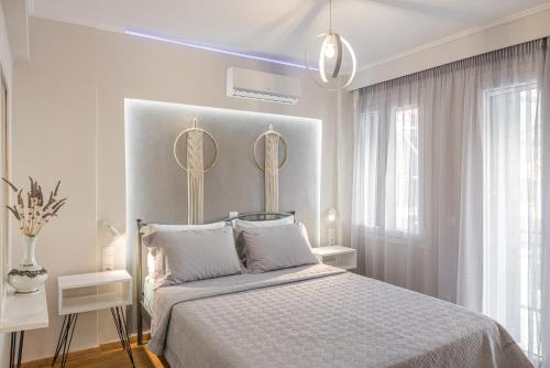 um quarto com uma cama com dois espelhos na parede em Pythagorio Blue Street Apartment with Balcony em Pythagoreio