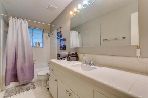 a bathroom with a sink and a toilet and a mirror at Lovely Little Rock Home with Fire Pit and Yard! in Little Rock