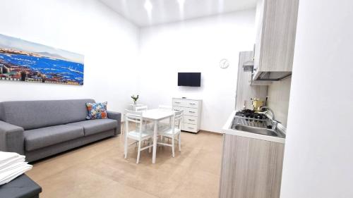 a living room with a couch and a table at La bella costiera home in Sant'Egidio del Monte Albino