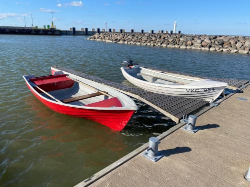two boats are docked at a dock in the water at Sadama majutus in Triigi