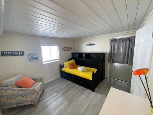 a room with a bed and a couch in it at Latitude adjustment, walk to beach in Myrtle Beach