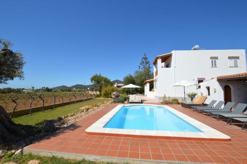 a villa with a swimming pool and a house at Cas Torres in Sant Jordi