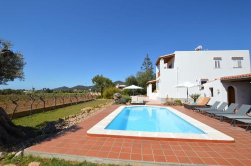 eine Villa mit einem Pool und einem Haus in der Unterkunft Cas Torres in Sant Jordi