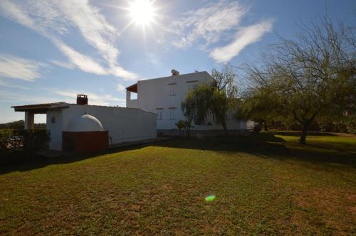 a white building with the sun in the sky at Cas Torres in Sant Jordi
