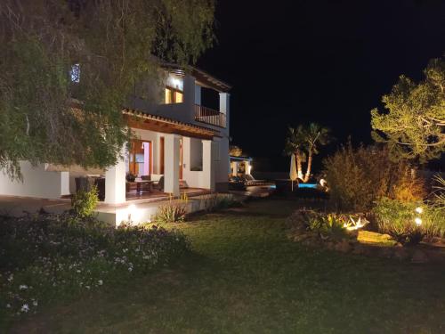 a house with a lit up yard at night at Cas Torres in Sant Jordi
