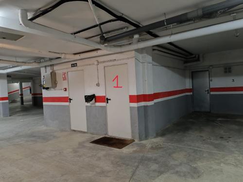 an empty room with doors and red and white stripes at InmoCyma Verdiblanco Familias-Valle de Benasque in Benasque