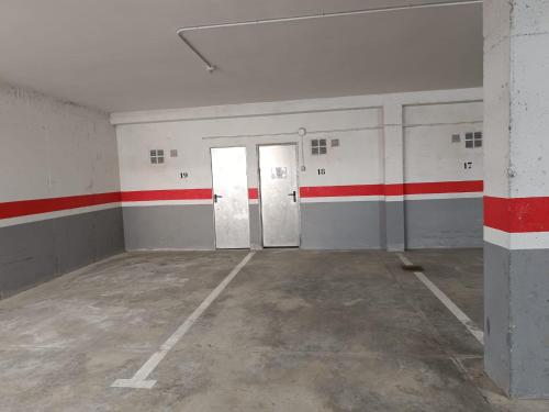 an empty room with red and white stripes on the walls at InmoCyma Verdiblanco Familias-Valle de Benasque in Benasque