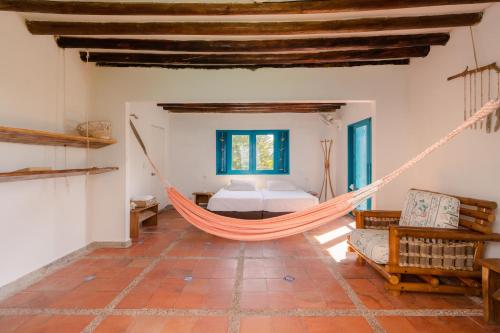 a hammock in a room with a bedroom at Casa Tinti in Tintipan Island