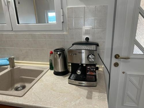 a coffee maker sitting on a counter next to a sink at THEODORA SUITE SMART KEY BOX by PROJECT 86 IKE in Agrinio