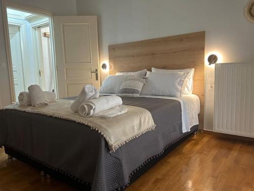 a bedroom with a large bed with towels on it at THEODORA SUITE SMART KEY BOX by PROJECT 86 IKE in Agrinio