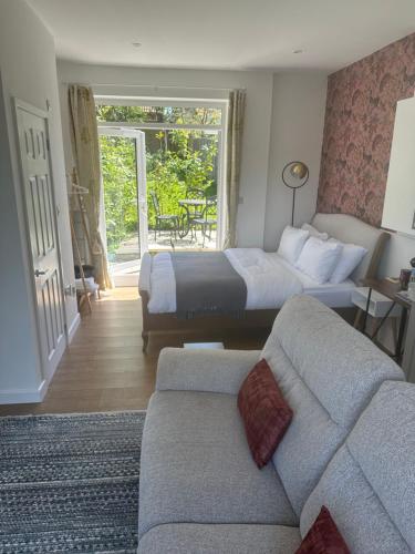 a hotel room with a bed and a couch at Springbank Studio in Fareham