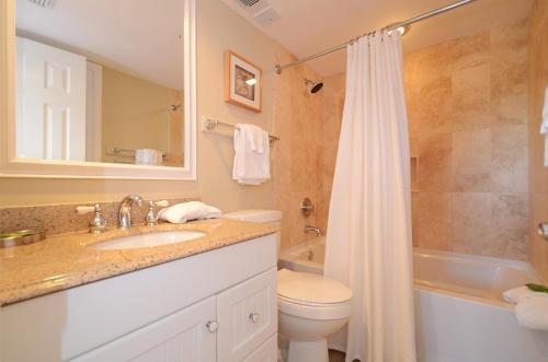 a bathroom with a sink and a toilet and a shower at One Seagrove Place 0908 in Santa Rosa Beach