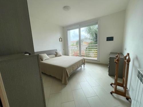 A bed or beds in a room at I Giardini di Pula "La terrazza"
