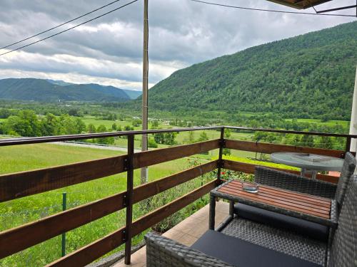 a balcony with a bench and a view of mountains at Apartments Denis in Tolmin