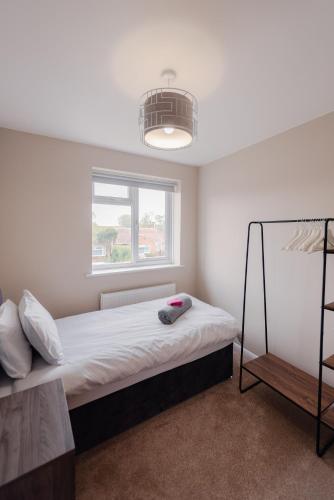 a bedroom with a bed and a window at Luxury Recently Renovated 3 Bedroom home in Sandwich Kent in Sandwich