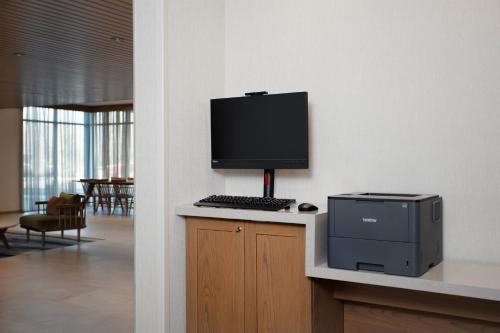 a computer monitor and a printer on a counter at Fairfield by Marriott Inn & Suites Indianapolis Plainfield in Plainfield