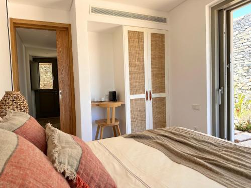 a bedroom with a bed and a sliding glass door at Egeo Paros in Kampos Paros
