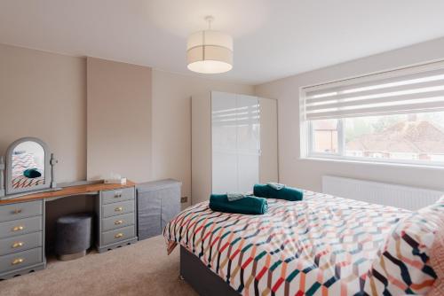 Schlafzimmer mit einem Bett, einem Schreibtisch und einem Fenster in der Unterkunft Luxury Recently Renovated 3 Bedroom home in Sandwich Kent in Sandwich