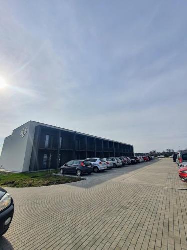 a parking lot with cars parked in front of a building at MDS Bonikowo in Bonikowo