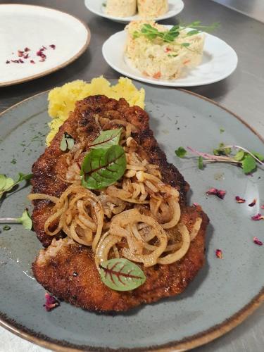 a plate of food with noodles on a table at MDS Bonikowo in Bonikowo