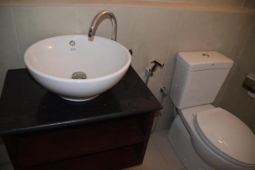 a bathroom with a sink and a toilet at Sanmali Beach Hotel in Marawila
