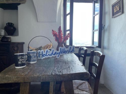 a wooden table with two mugs on top of it at Lover's Nest by Holiday World in Baiardo