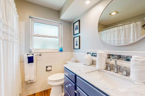 a bathroom with a toilet and a sink and a mirror at Caloosahatchee Independence in Cape Coral