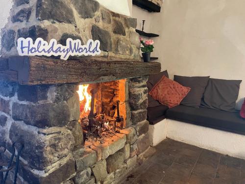 a brick fireplace with a fire in it at Lover's Nest by Holiday World in Baiardo