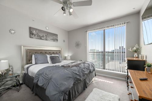 a bedroom with a bed and a large window at Relaxstay - Private Spacious 1br Apartment near Galleria Dallas in Dallas