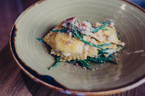 a plate of food on a wooden table at The Bulls Head Hotel in Hale