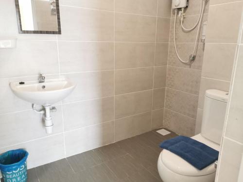 La salle de bains est pourvue de toilettes et d'un lavabo. dans l'établissement Mutiara Melaka Beach Resort, à Tangga Batu