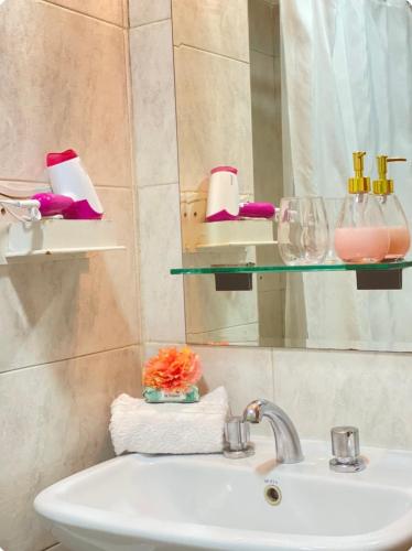 a bathroom with a sink and a mirror at MENDOZA Suites 1 -con estacionamiento opcional- in Mendoza