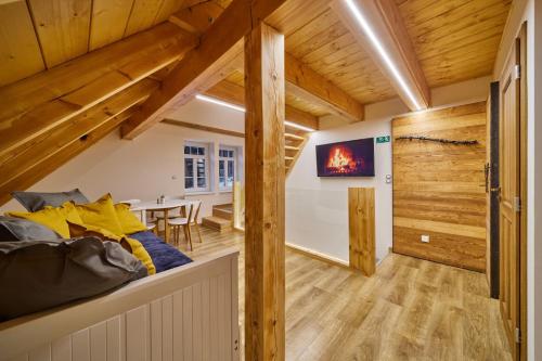 a room with a bed and a dining room at Urlas Apartments, dog friendly, shortcut to Sněžka Mountain in Pec pod Sněžkou