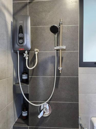 a shower in a bathroom with a phone on the wall at Penang Georgetown 3BRCPGF The Martian #TvBox in Jelutong