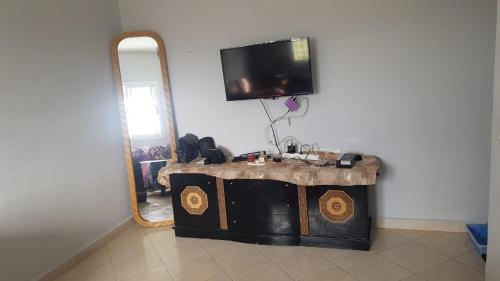 Zimmer mit einem Spiegel und einem TV an der Wand in der Unterkunft Mouad house in Martil