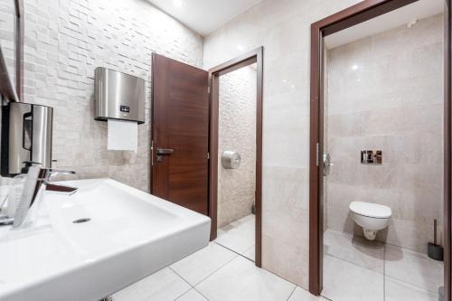 a bathroom with a sink and a toilet at Hotel Zlaté Košice - Self reception in Košice