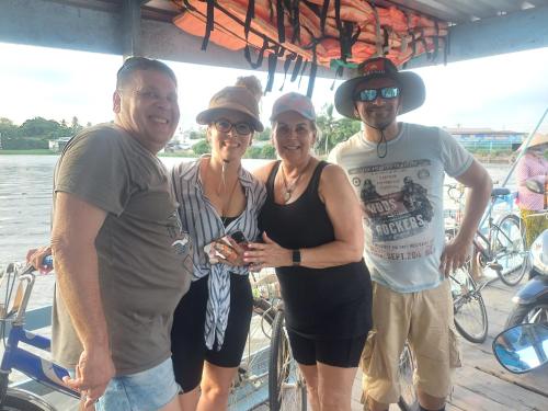 a group of people posing for a picture on a boat at AUTHENTIC HOMESTAY in Can Tho