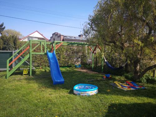 a playground with a slide in a yard at Apartamenty Mewa in Rewa