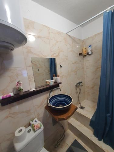 a bathroom with a sink and a shower with a mirror at St.Barbara studio in Drama