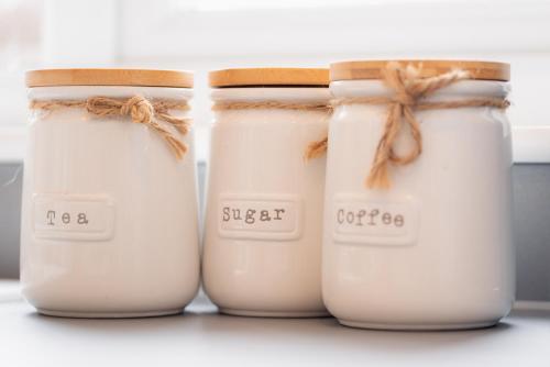a group of three candles sitting on a shelf at Luxury Recently Renovated 3 Bedroom home in Sandwich Kent in Sandwich