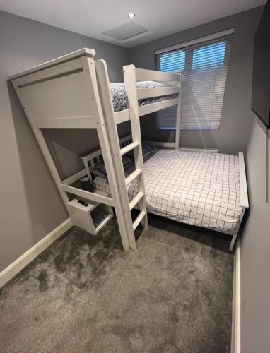 a bunk bed room with two bunk beds in it at The Little house with a Tub in Bangor