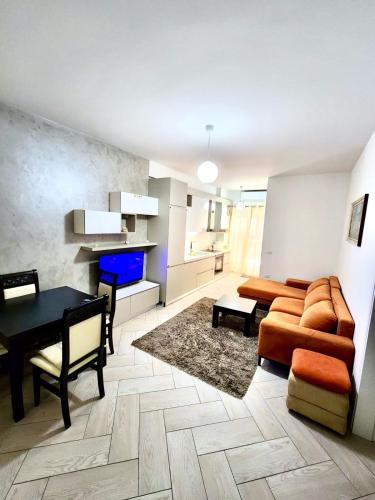 a living room with a couch and a table at Onis Apartment in Vlorë
