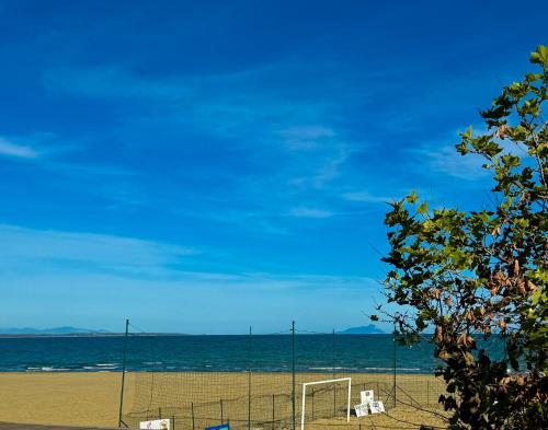a beach with chairs and a soccer goal at Marco House - Seaview Apartment - Fronte Mare - Casa Vacanza in Anzio