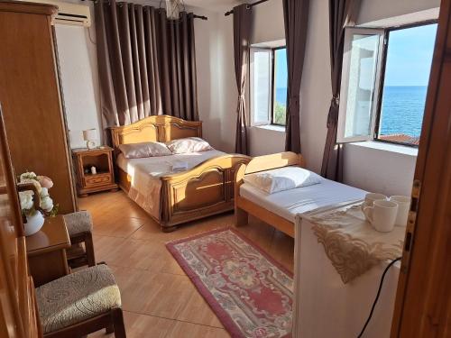 a hotel room with two beds and a window at Guest house Naser in Ulcinj