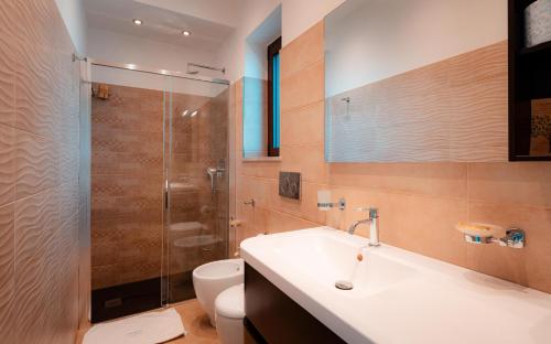 a bathroom with a toilet and a sink and a shower at Pascià Madonna Rocca in Taormina