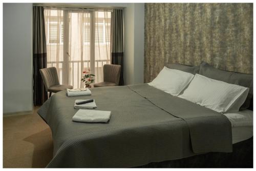 a bedroom with a large bed with two towels on it at Last Point Süit Apart in Eskisehir