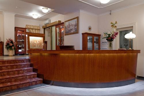 a lobby with a reception desk and stairs at Amigo City Centre in Prague