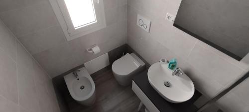 a small bathroom with a toilet and a sink at Al Duca San Pietro in Carloforte