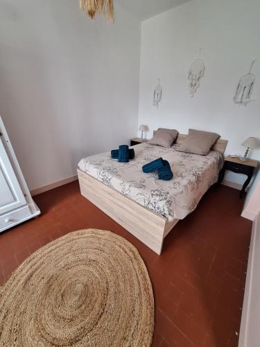 a bedroom with a bed and a large rug at Gîte au gré du Canal in Selles-sur-Cher