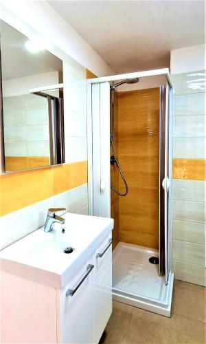 a bathroom with a white sink and a shower at La bella costiera monolocale in Sant'Egidio del Monte Albino